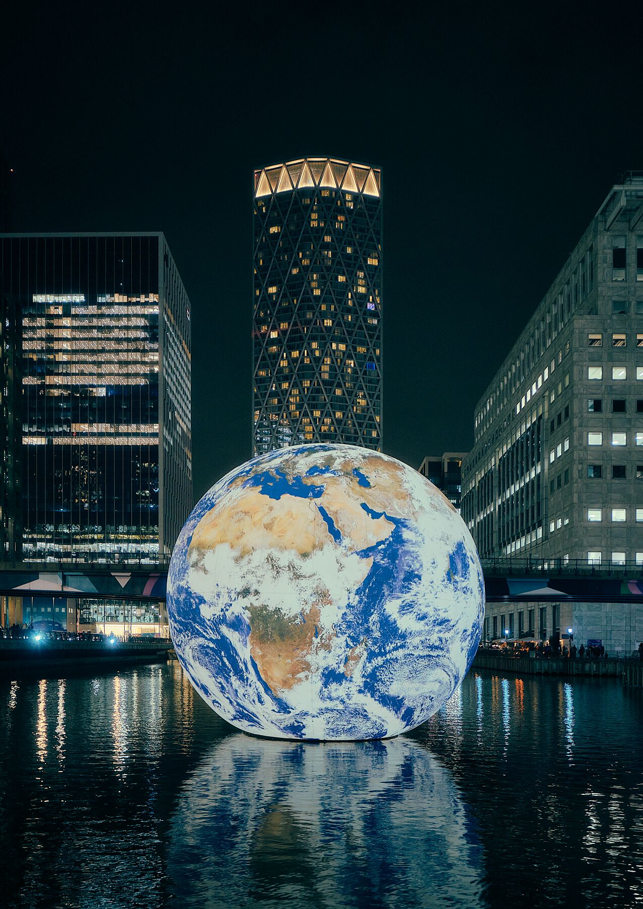 Floating Planet - This stunning urban photo of our dear planet Earth floating in a wharf will provoke a thoughtful conversation with anyone who sees it on your wall.